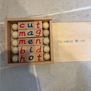Montessori spin-and-read wood phonics blocks for CVC words.